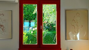 A door with two framed artworks on either side. - AIR-CONDITIONED, SINGLE-STOREY VILLA, SEA AND CORSICAN VIEWS LARGE GARDEN, DOGS ALLOWED (Villeneuve-Loubet)