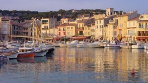 A marina with boats docked, surrounded by colorful buildings.