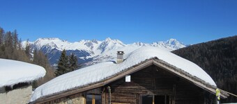 Typical Savoyard chalet with roof shingles, tufa walls and foist
