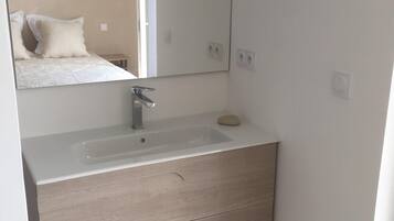 Shower, hair dryer, towels, toilet paper