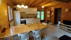 A wooden cabin interior with a kitchen, dining area, and living space. - Burgundy, cottage, cottage, calm, tranquility, rest, southern Morvan (Corancy)