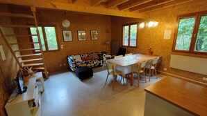 A wooden interior with a dining table, chairs, a sofa, and a staircase. - Burgundy, cottage, cottage, calm, tranquility, rest, southern Morvan (Corancy)