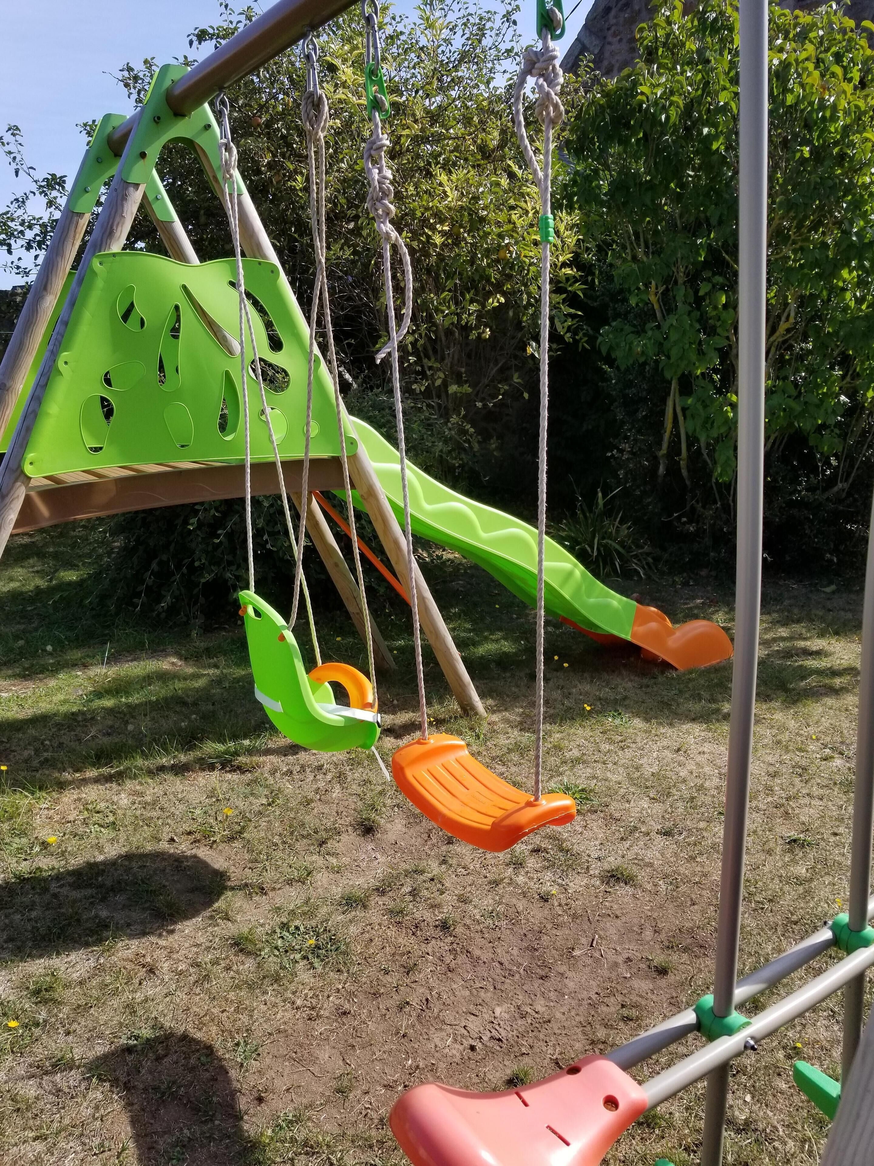 A playground with swings and a slide.