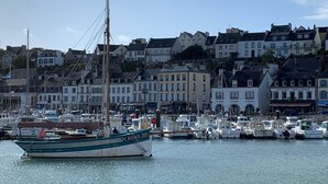 A harbor with boats docked and buildings in the background.
