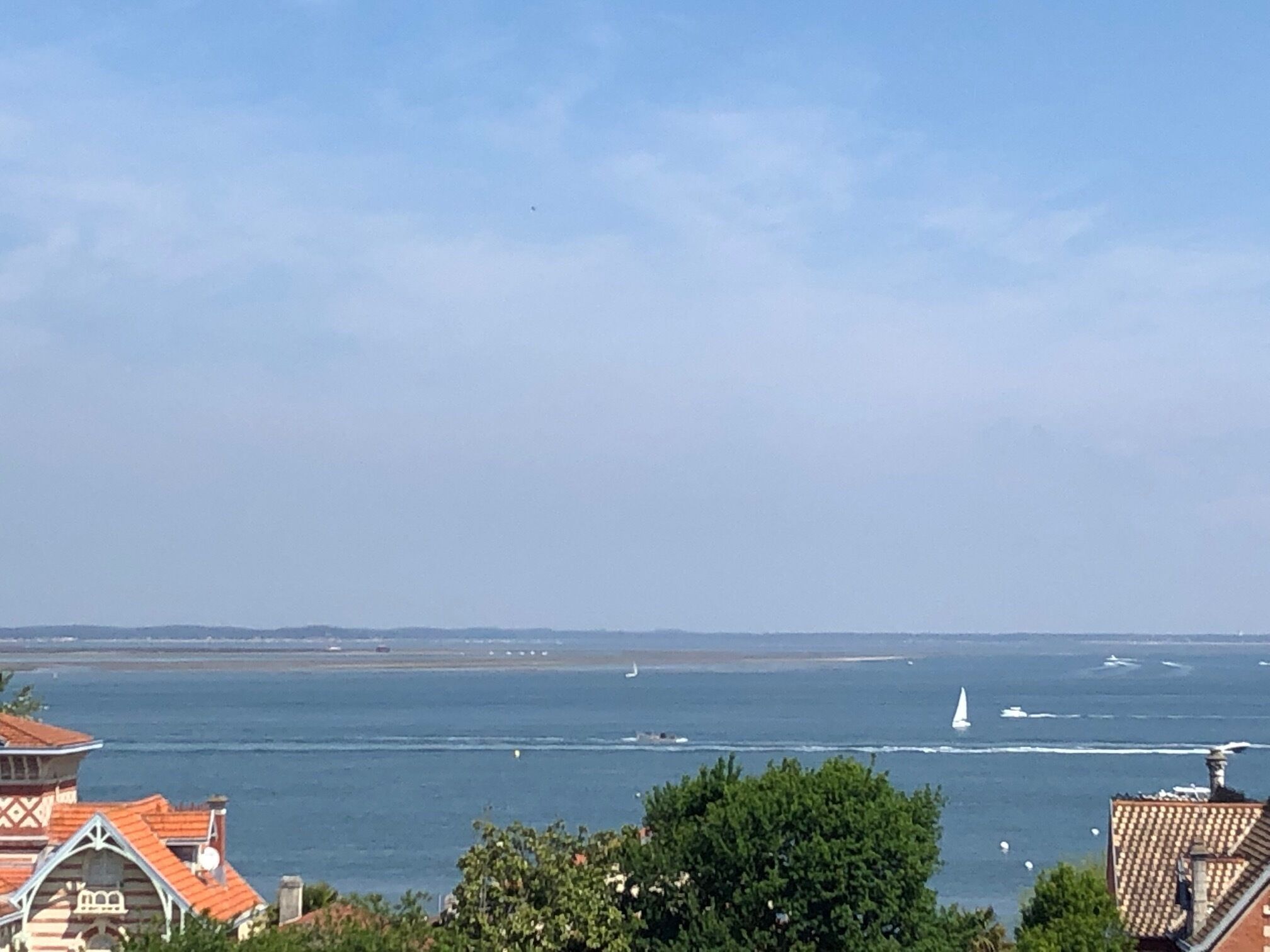 A coastal view with buildings and a clear sky.
