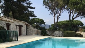 A rectangular swimming pool with clear blue water, surrounded by a stone wall and a paved deck. - House for rent gulf of St Tropez 2 bedrooms in residence with swimming pool tennis (Gassin)