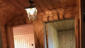 A wooden interior with a bed, a nightstand, and a chair. - Gérardmer, superb valley view, Gite ****, Internet, TV, Short Stay adm (Rochesson)