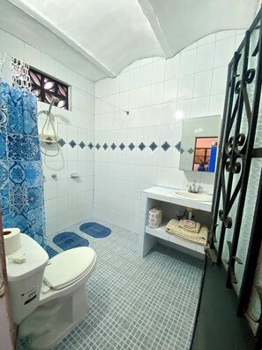 Shower, hair dryer, towels, toilet paper