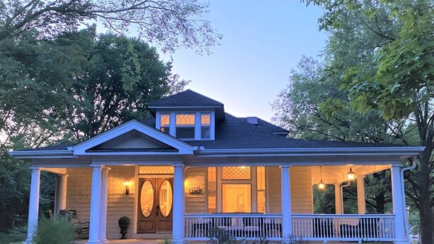 A two-story house with a front porch, a covered entryway, and a well-maintained lawn. - Amazing Home & Area - Close to Downtown Nashville! Family & Group Friendly! (Nashville)