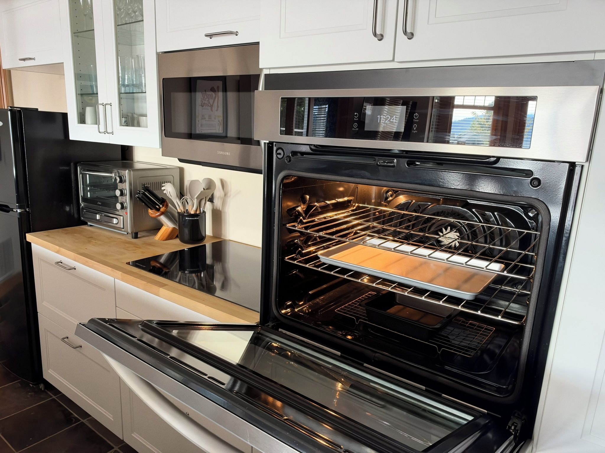 A kitchen with a stainless steel oven, a toaster, and a microwave.