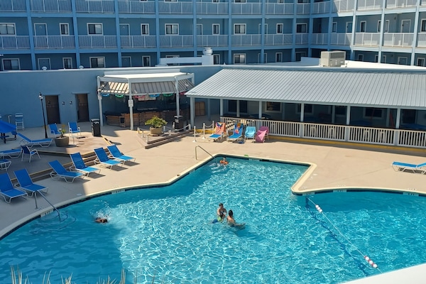 VIEW FROM OUR FRONT DOOR. POOL ,PATIO, AND BEACH BEACH RESTAURANT STORE, BAR.