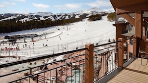 A ski resort with a view of a snowy mountain, a ski lift, and a pool area. - Spacious Luxury Two-Bedroom at Grand Lodge at Peak 7! (Breckenridge)