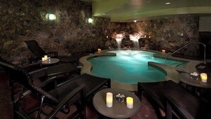 A spa area with a hot tub, lounge chairs, and candles. - Spacious Luxury Two-Bedroom at Grand Lodge at Peak 7! (Breckenridge)