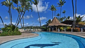 A swimming pool with a dolphin design, surrounded by palm trees and lounge chairs. - Spacious Studio Beach Chic, Walk to Sandy Napili Bay-Napili Shores C116 (Lahaina)
