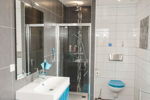 Shower, hair dryer, towels, toilet paper