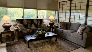 A living room with two sofas, a coffee table, and lamps. - 2 bdrm 2 Bath Condo with Partial Ocean Views, Steps away from Kamaole III Beach  (Kihei)