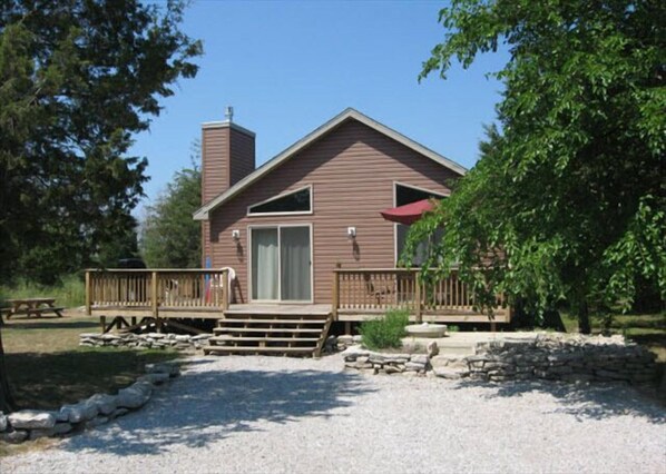 Relax on the front deck or enjoy a tranquil garden view from this cabin's inviting outdoor space.