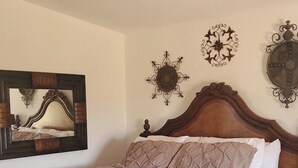 A bedroom with a wooden bed, a ceiling fan, and decorative wall art. - 5 Minutes From The Lake! Million Dollar Views! (Page)