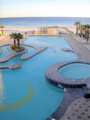 Relax by the ocean-view pool, featuring a unique design with multiple sections and lounge chairs.