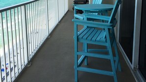 A balcony with a view of the ocean, a table, and two chairs. - Beautiful Condo On The Gulf, Walking Distance to Pier Park (Panama City Beach)