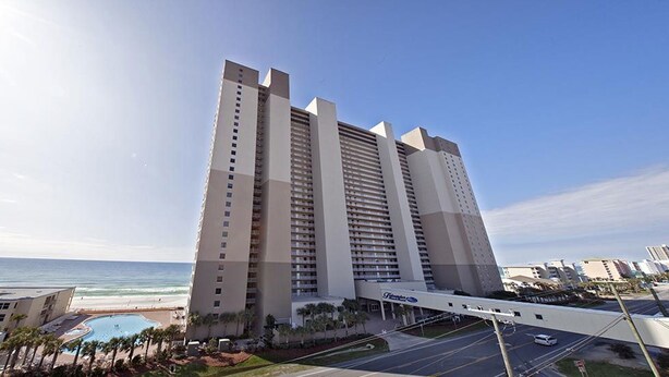 A high-rise hotel with a pool and beach view, located near a coastal area. - Beautiful Condo On The Gulf, Walking Distance to Pier Park (Panama City Beach)