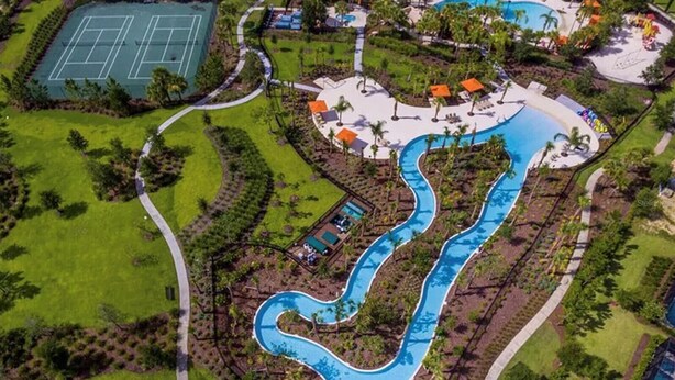 An aerial view of a resort with a winding pool, tennis courts, and a variety of outdoor amenities. - Spacious 6BR Family Retreat w/ Private Pool and Spa in Resort Community! (Davenport)