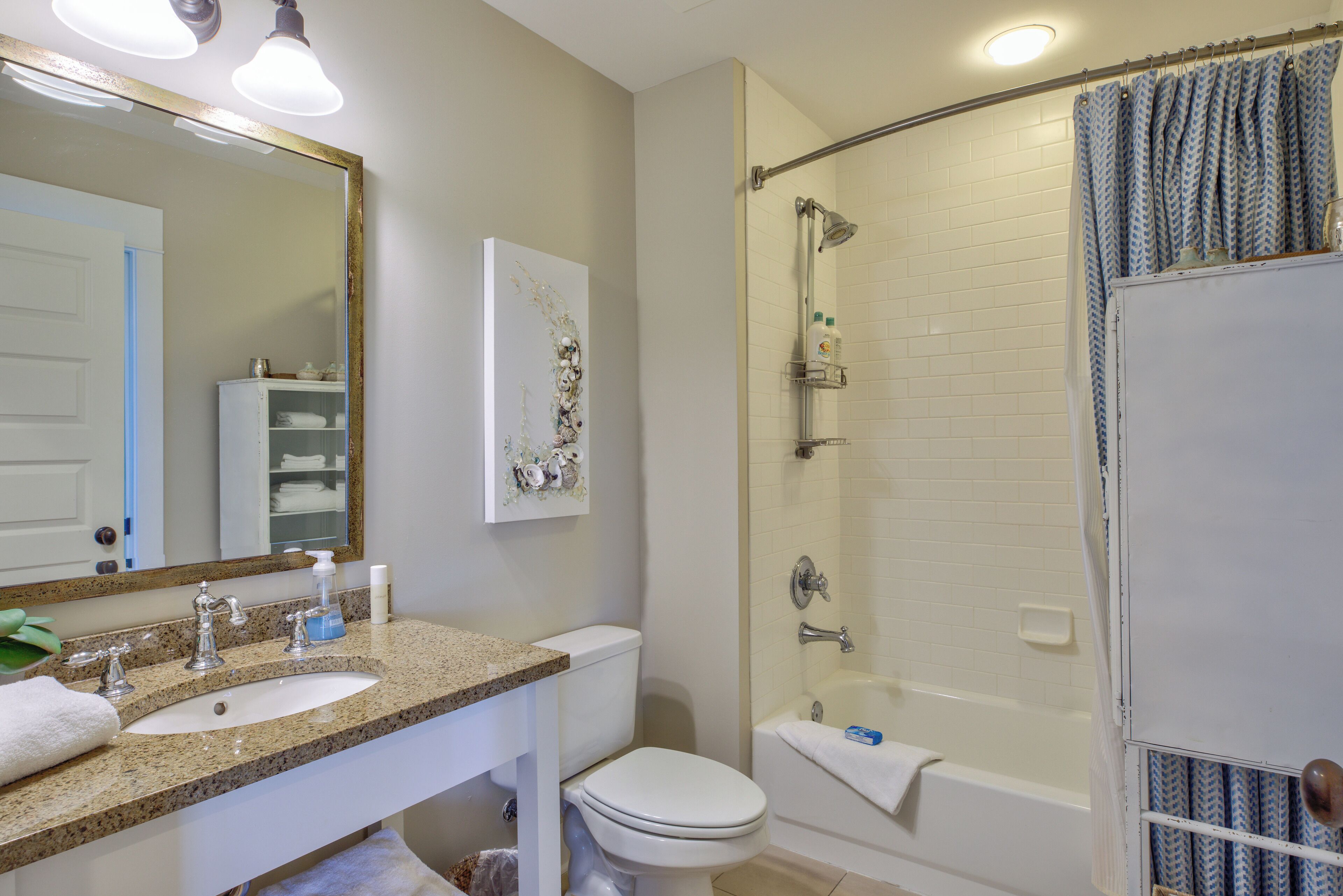 A bathroom with a sink, toilet, and bathtub.
