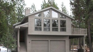 A two-story house with a garage, a covered porch, and a deck. - Family Friendly, Air Conditioning - SHARC passes included. (Sunriver)