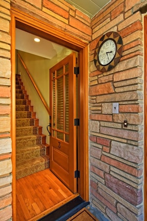 A wooden staircase leading to a door with a number plate '1'. - FABULOUS 2BD CONDO - AC - PRIVATE DECK WITH VIEW - 5 STAR RATINGS (Seattle)