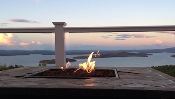A fire feature with a view of a body of water and distant landforms. - Ski Gunstock 3 minutes away then relax overlooking lakeWinnipesaukee







mile (GILFORD)