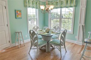 Guests can dine in comfort at this stylish dining area, surrounded by lush views and natural light.