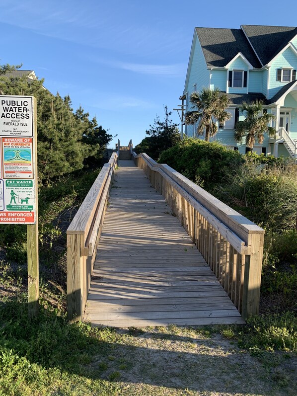 Stroll along the boardwalk to charming coastal homes surrounded by lush greenery and scenic views.