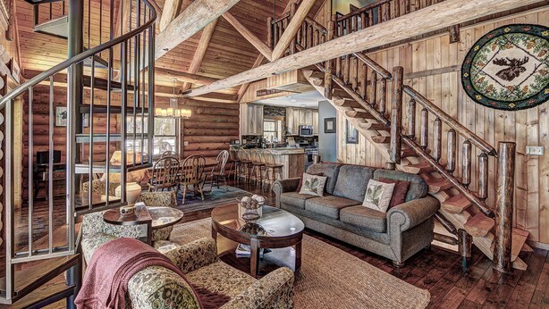 A log cabin interior with a cozy living area, a dining space, and a kitchen. - Yellow Birch Lodge - Private Vacation Rental Home       (Eagle River)