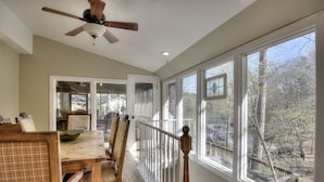 A dining area with a wooden table, chairs, and a ceiling fan. - Hattiway on Lake Allatoona Includes Private Covered Dock (Lake Allatoona)