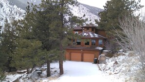 A two-story wooden house with a garage, surrounded by snow-covered ground and trees. - Beautiful, pet friendly and at the foot of Saxon Mountain in Georgetown Colorado (Georgetown)