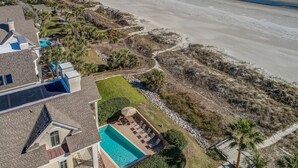 A beachfront property with a swimming pool, a beach, and a view of the ocean. - Direct Oceanfront Luxury Home, Large Private Pool and Spa, Elevator, Concierge! (Hilton Head Island)