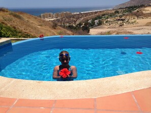 A swimming pool with clear blue water, surrounded by a tiled deck. - Luxury Resort Villa That Sleeps 10 (Cabo San Lucas)