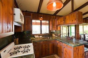 Enjoy cooking in this well-equipped kitchen with a central island, microwave, and gas stove.