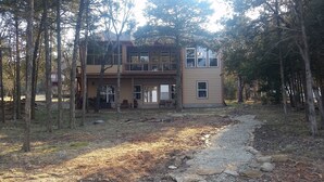 A two-story house surrounded by trees. - “A Shore Thing “ A Gorgeous Lakefront Home Steps Away From Beaver Lake (Garfield)