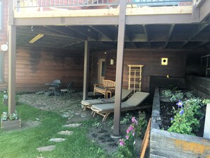 Enjoy al fresco dining and socializing in this serene outdoor patio area with a seating space and garden.