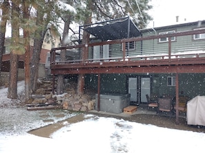 A two-story building with a covered outdoor area, stone wall, and wooden deck. - 1 of the Safest neighborhoods in America. Unique one of a kind with Hot Tub. (Sandy)