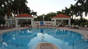 A swimming pool with lounge chairs and two gazebos labeled "Club" and "Baker's".