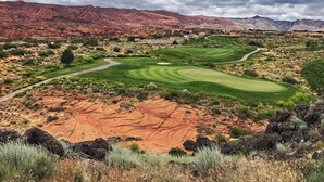 A golf course with a desert landscape, red rock formations, and a cloudy sky. - ENTRADA GATED STUNNING VIEWS Dog Friendly New Universal EV TESLA Charger    (Santa Clara)