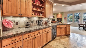 A kitchen with wooden cabinets, granite countertops, and a built-in dishwasher. - ENTRADA GATED STUNNING VIEWS Dog Friendly New Universal EV TESLA Charger    (Santa Clara)