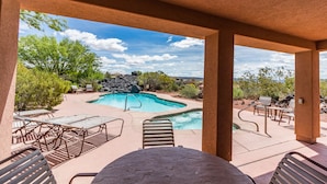 A pool area with lounge chairs and a table, surrounded by natural landscape and a clear sky. - ENTRADA GATED STUNNING VIEWS Dog Friendly New Universal EV TESLA Charger    (Santa Clara)