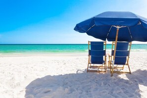 On the beach, sun-loungers