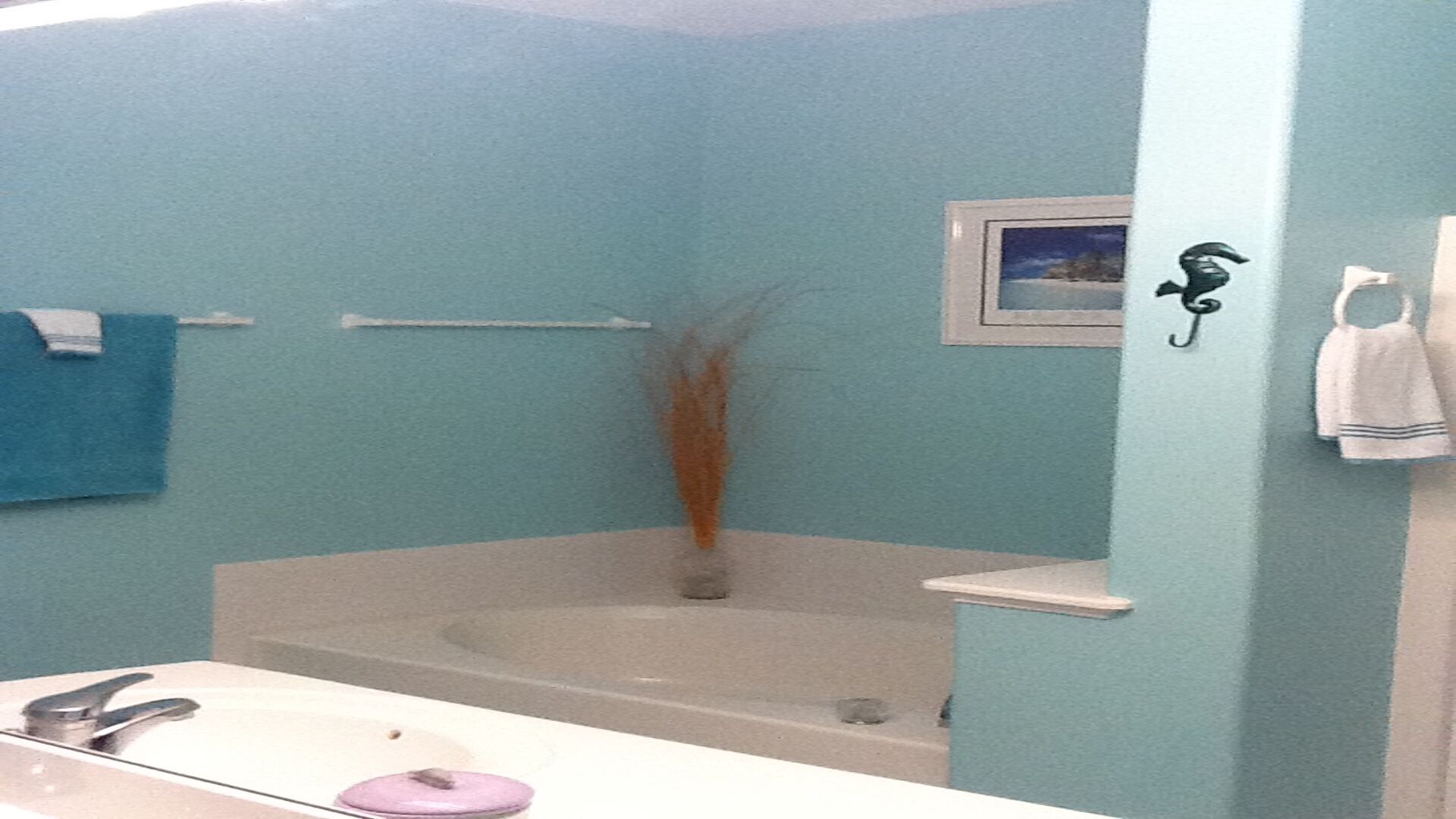 A bathroom with a bathtub, a sink, and a mirror.