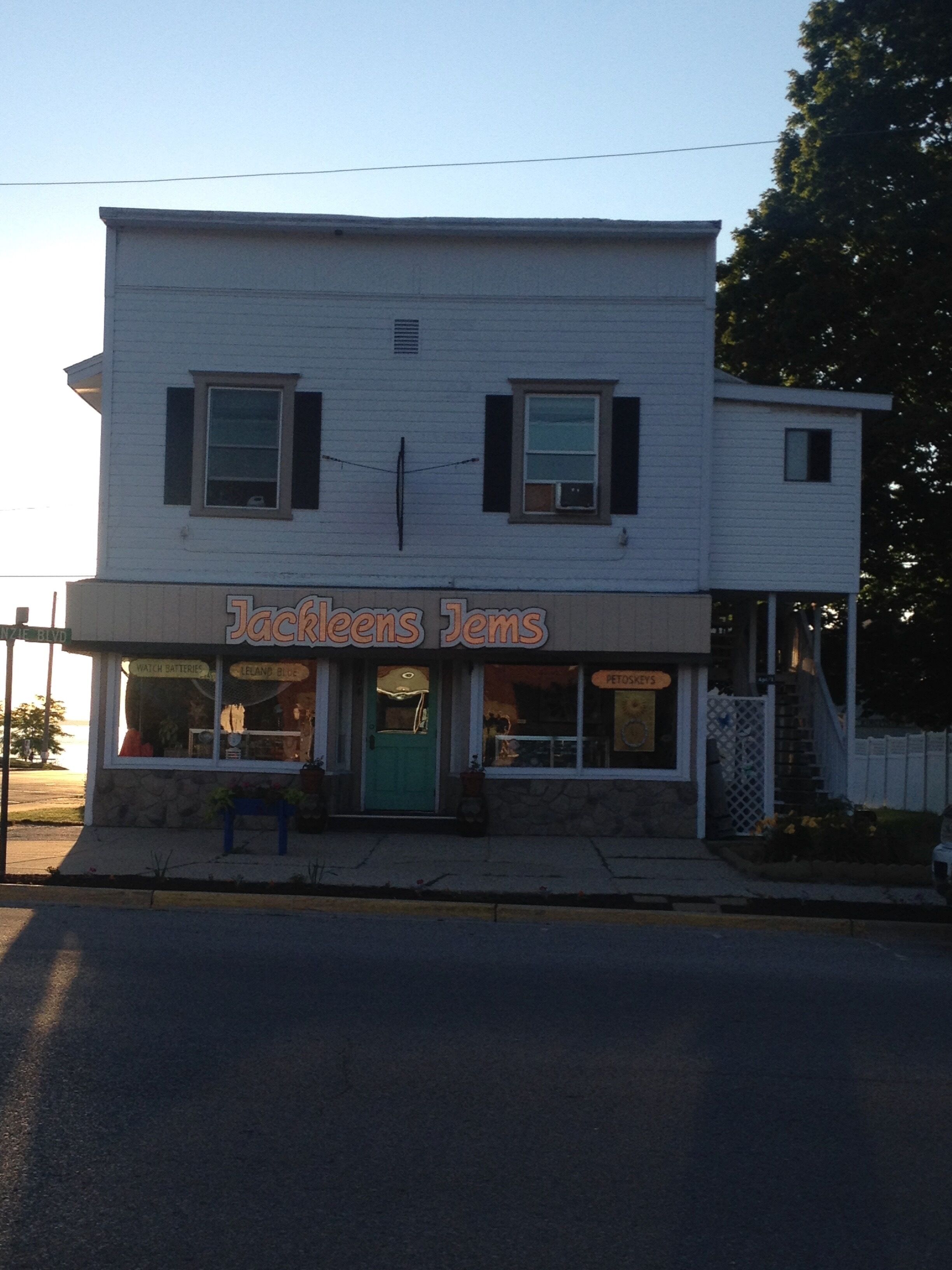 A two-story building with a storefront labeled "Jackleens Jems".