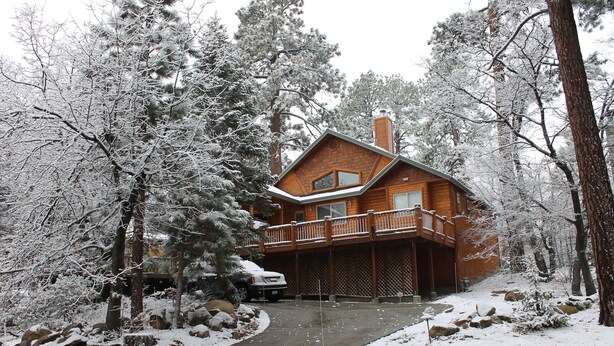 A wooden cabin with a balcony, surrounded by snow-covered trees and rocks. - 30 night minimum stay, Log Style Cabin in Moonridge, Walk To Slopes, Ntl. Forest (Big Bear Lake)