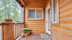 A wooden cabin with a porch, a window with shutters, and a door. - 30 night minimum stay, Log Style Cabin in Moonridge, Walk To Slopes, Ntl. Forest (Big Bear Lake)
